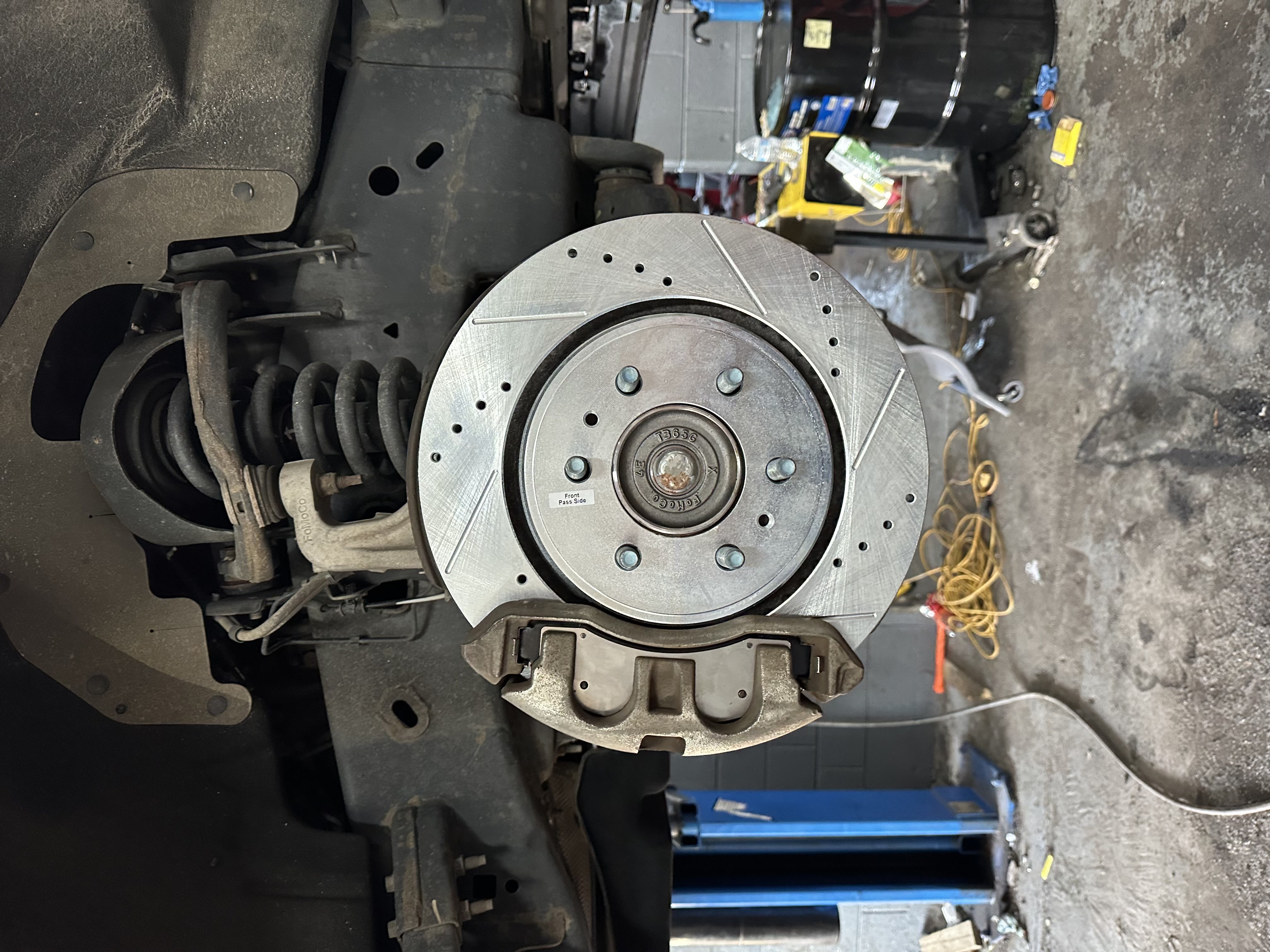 Fresh brake rotor and caliper installed on a vehicle