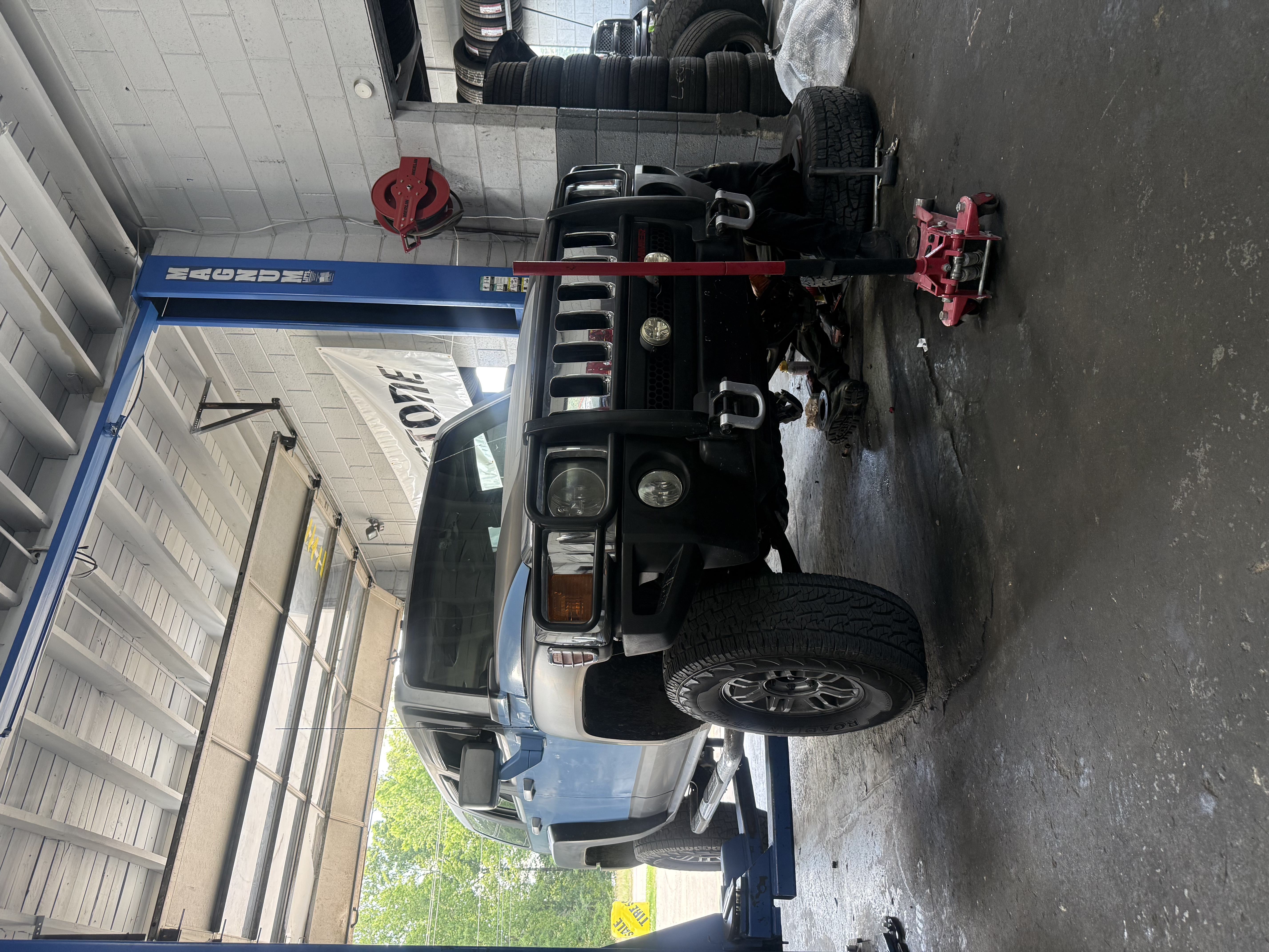 SUV raised for service inside the repair shop