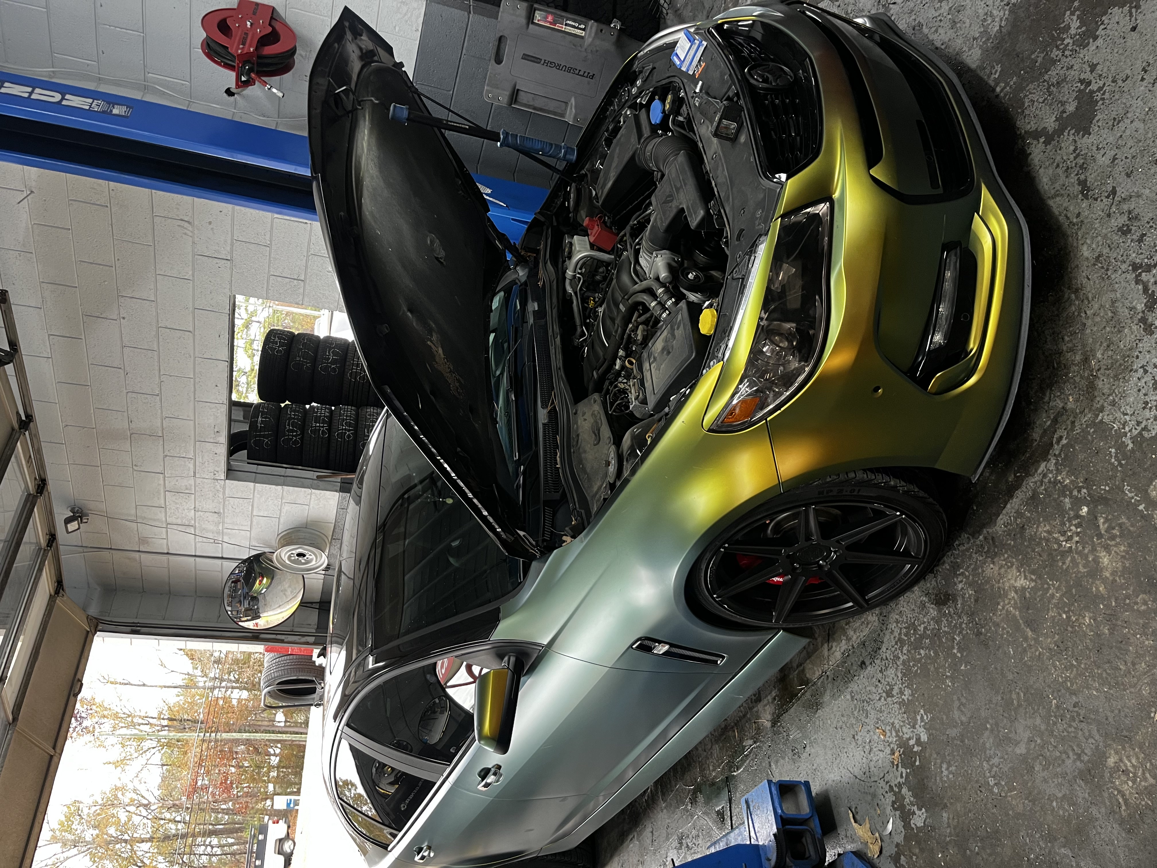 Performance sedan being serviced inside the Legacy Automotive shop